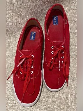 Keds Red Canvas Low-Top Sneakers with “Nike Lace Up. Save Lives.” laces